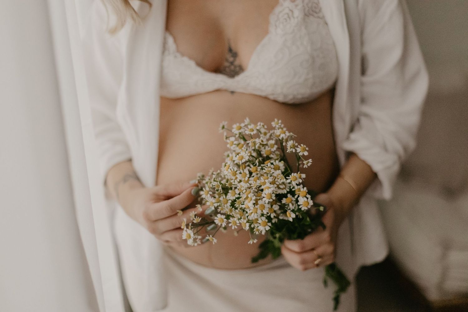 Romantic bridal details featuring lace and baby's breath flowers in soft natural light.