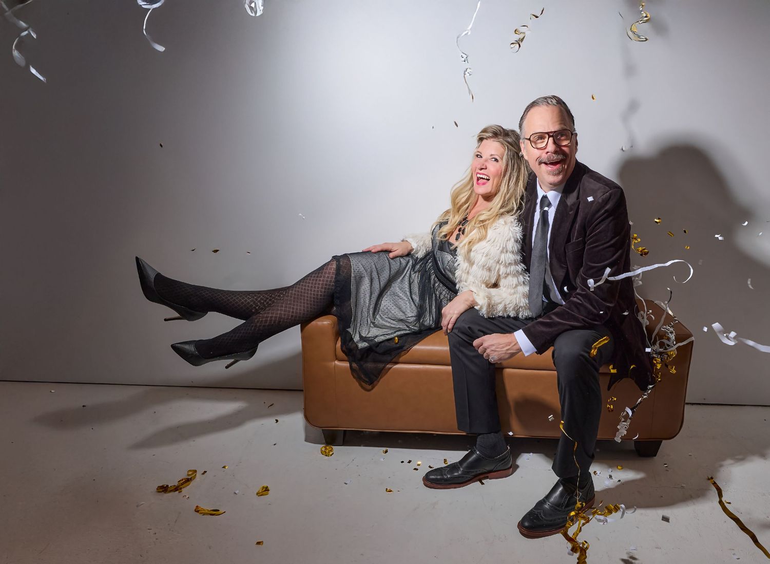 A sequence of images shows someone falling down while confetti scatters through the air in a white studio setting.