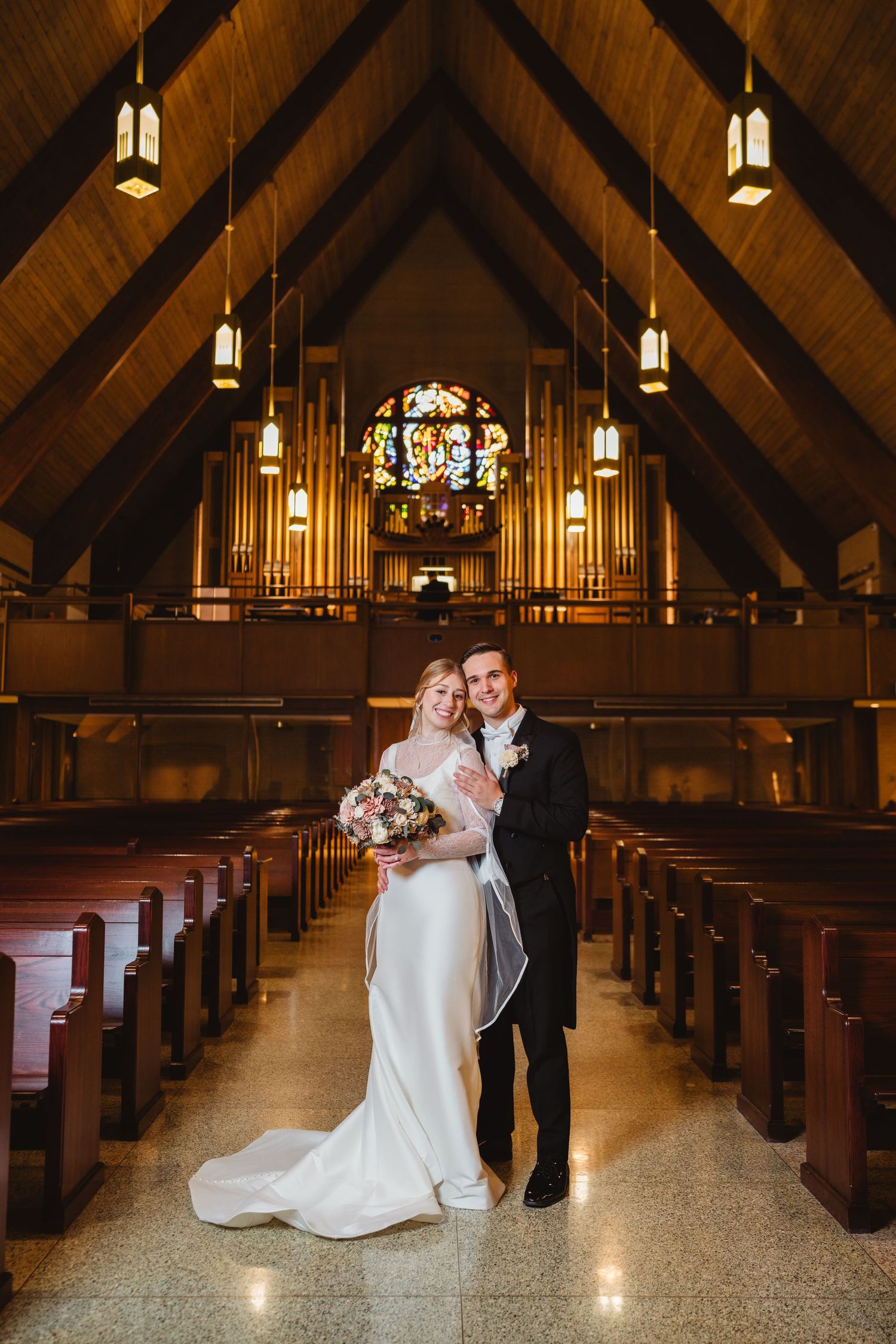 A series of photos showing the interior of a church sanctuary with wooden beams, pews and hanging pendant lights.