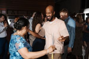 People dancing together at a social gathering in what appears to be a salsa or Latin dance event.
