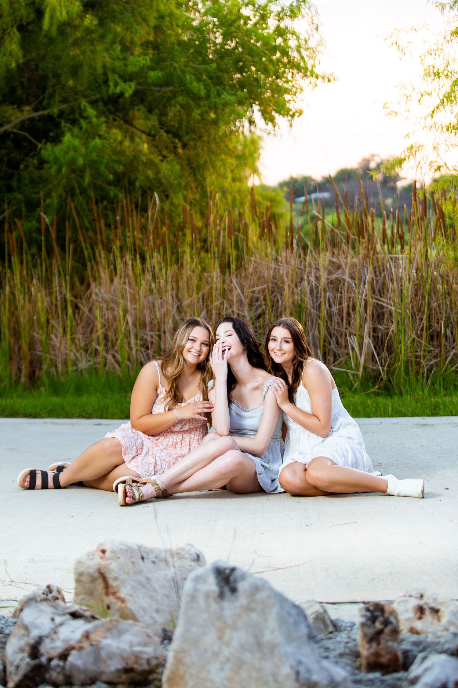 A portrait of three best friends laughing at Fischer Park in New Braunfels, Texas.