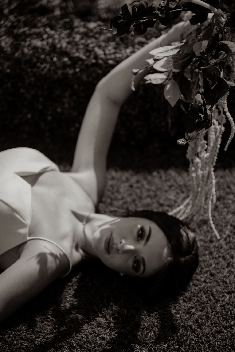 editorial bridal photo laying in garden in Dallas Texas with dramatic storytelling feel