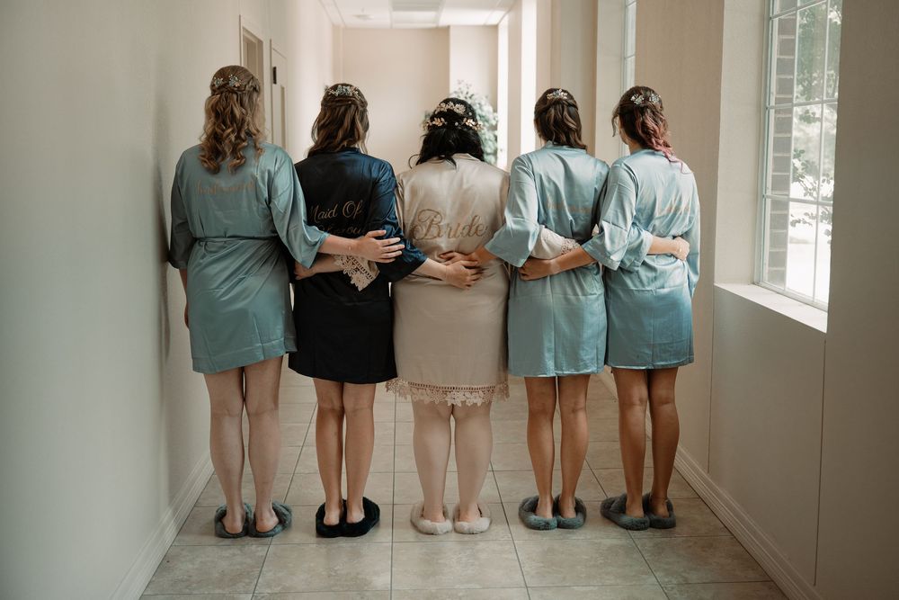 bride and bridesmaids in matching robes before Southlake Texas wedding ceremony