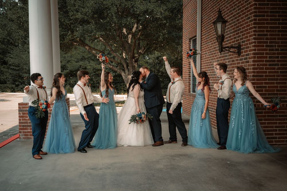 Bridesmaids and groomsmen celebrating newlyweds at Fort Worth chapel wedding