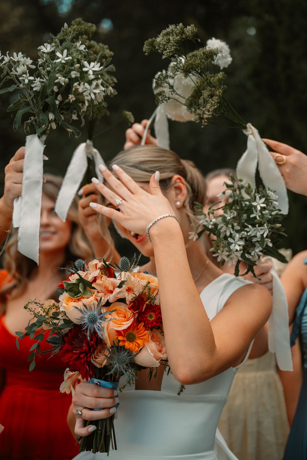 Closeup of bridal bouquet, bridesmaids bouquets and wedding ring in Clark Gardens by Jaime Layne Photography