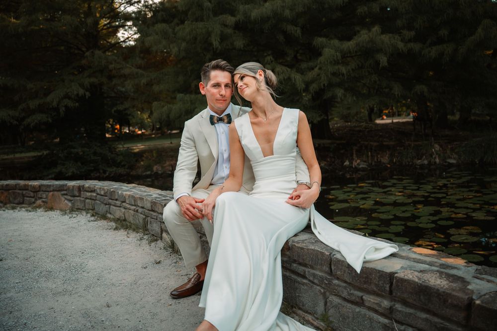 Bride and groom naturally posed in front of lily pond in DFW after ceremony