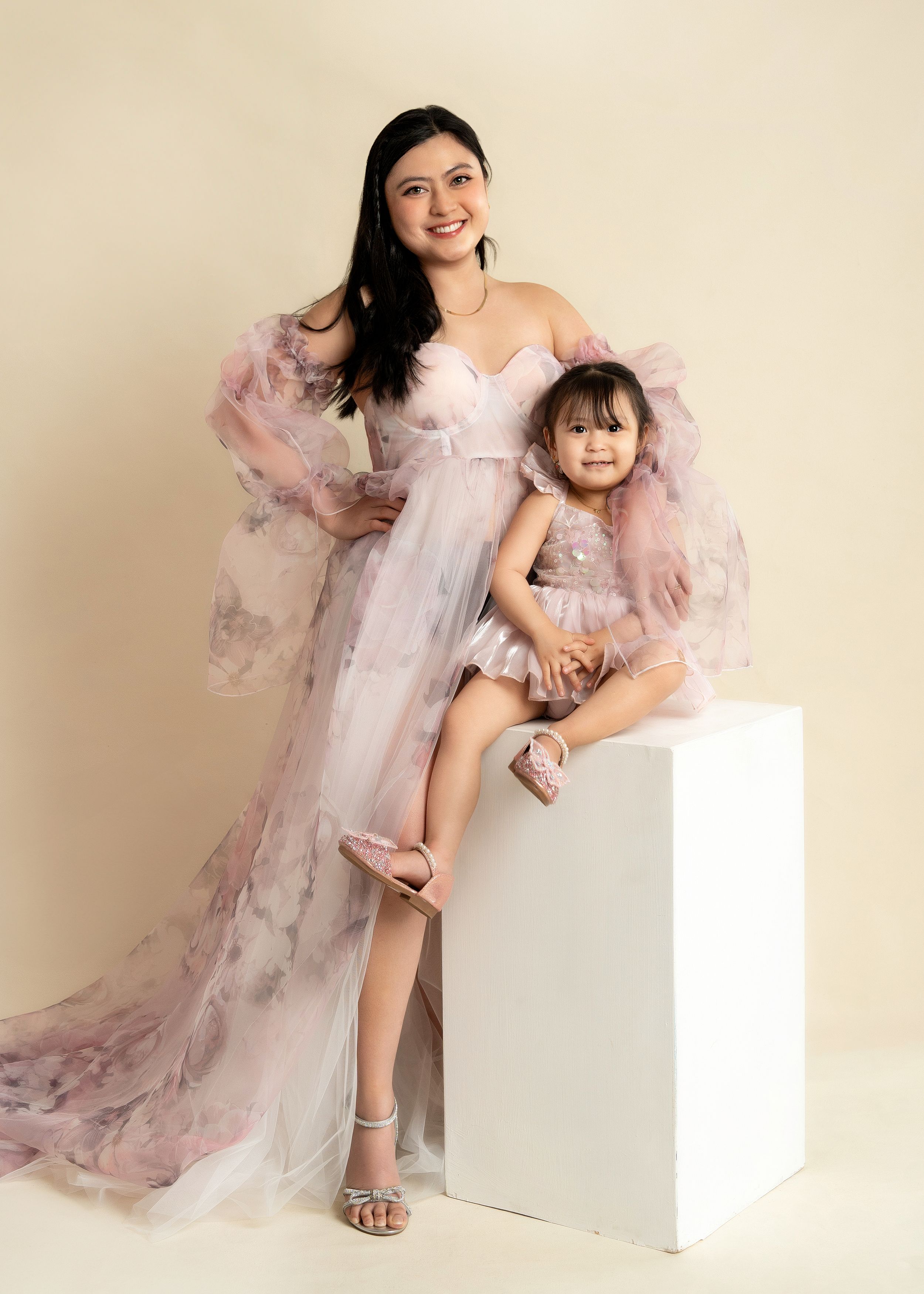 a mother stands behind her daughter in the studio with a motherhood photographer in minneapolis