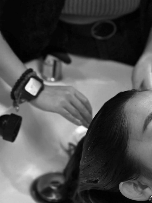 A woman getting her hair washed in a salon setting