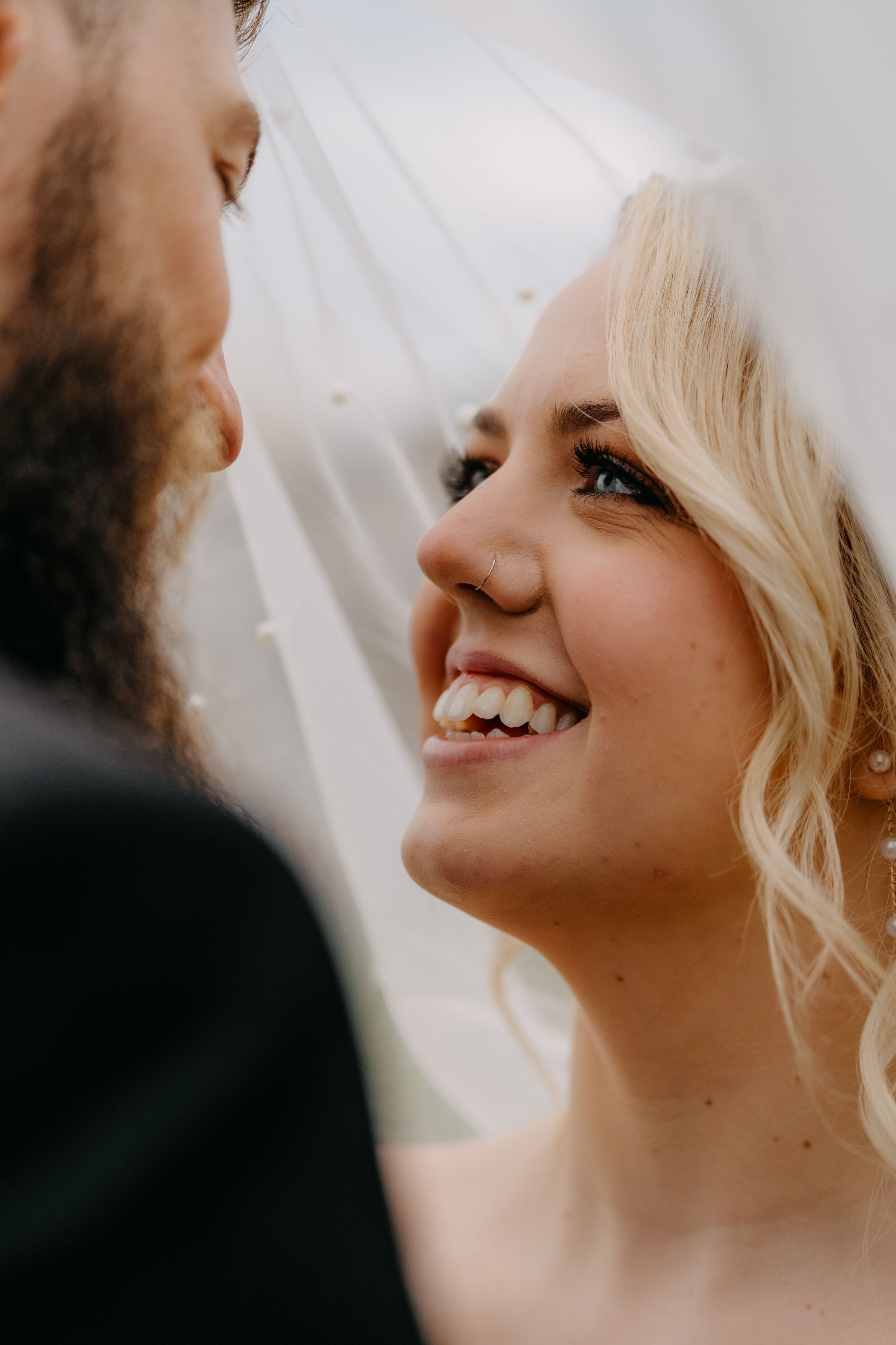 Close-up view of a joyful couple sharing an intimate moment during their wedding celebration.