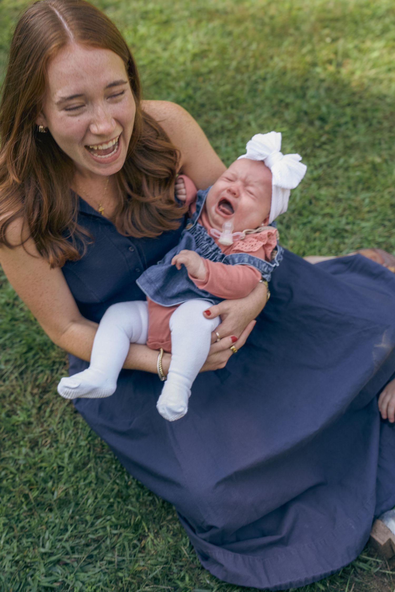 A series of candid photos showing joyful moments between parent and baby laughing together on grass.