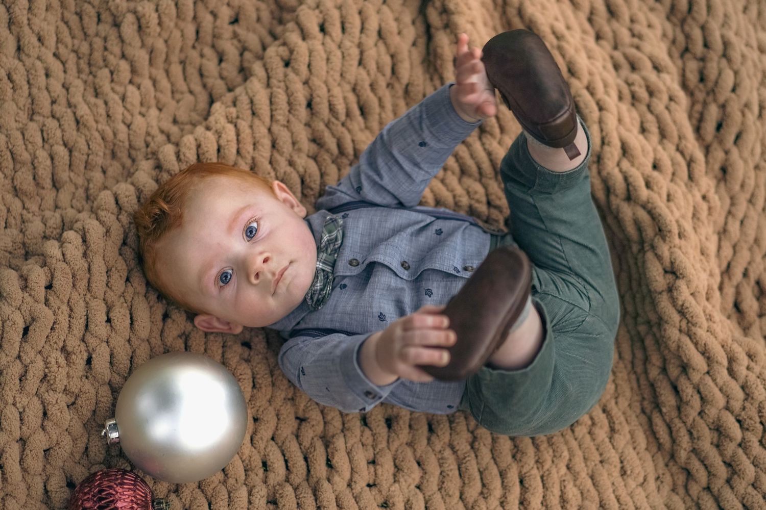 A sequence showing someone falling backwards onto a carpeted floor while juggling a silver exercise ball.