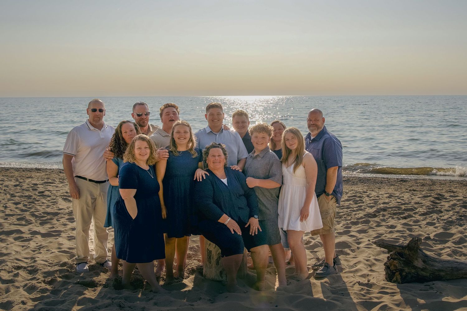 People gather as a group on a sandy beach at sunset creating cherished vacation memories.