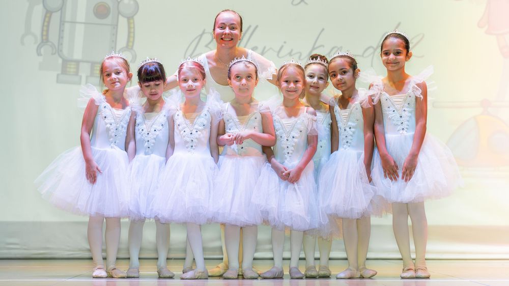 Ballet kids school photoshoot in Dubai featuring young ballerinas in white tutus posing gracefully