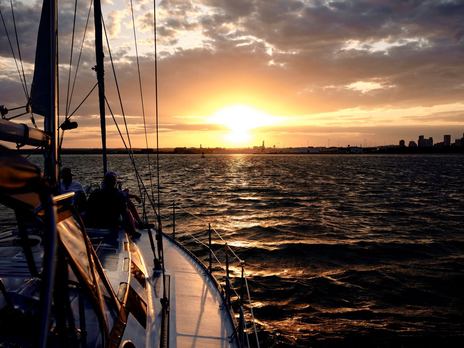 Sunset landscape photography of sailboat on the Patapsco River in Maryland.