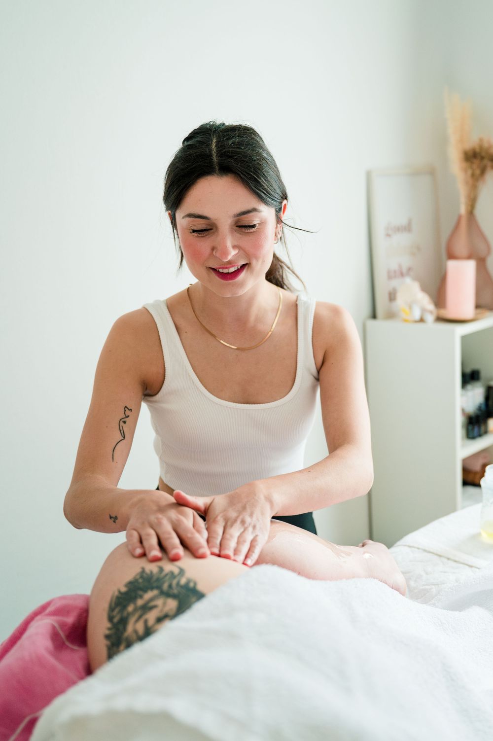 Massage therapist performing targeted hand movements during a professional spa treatment session.