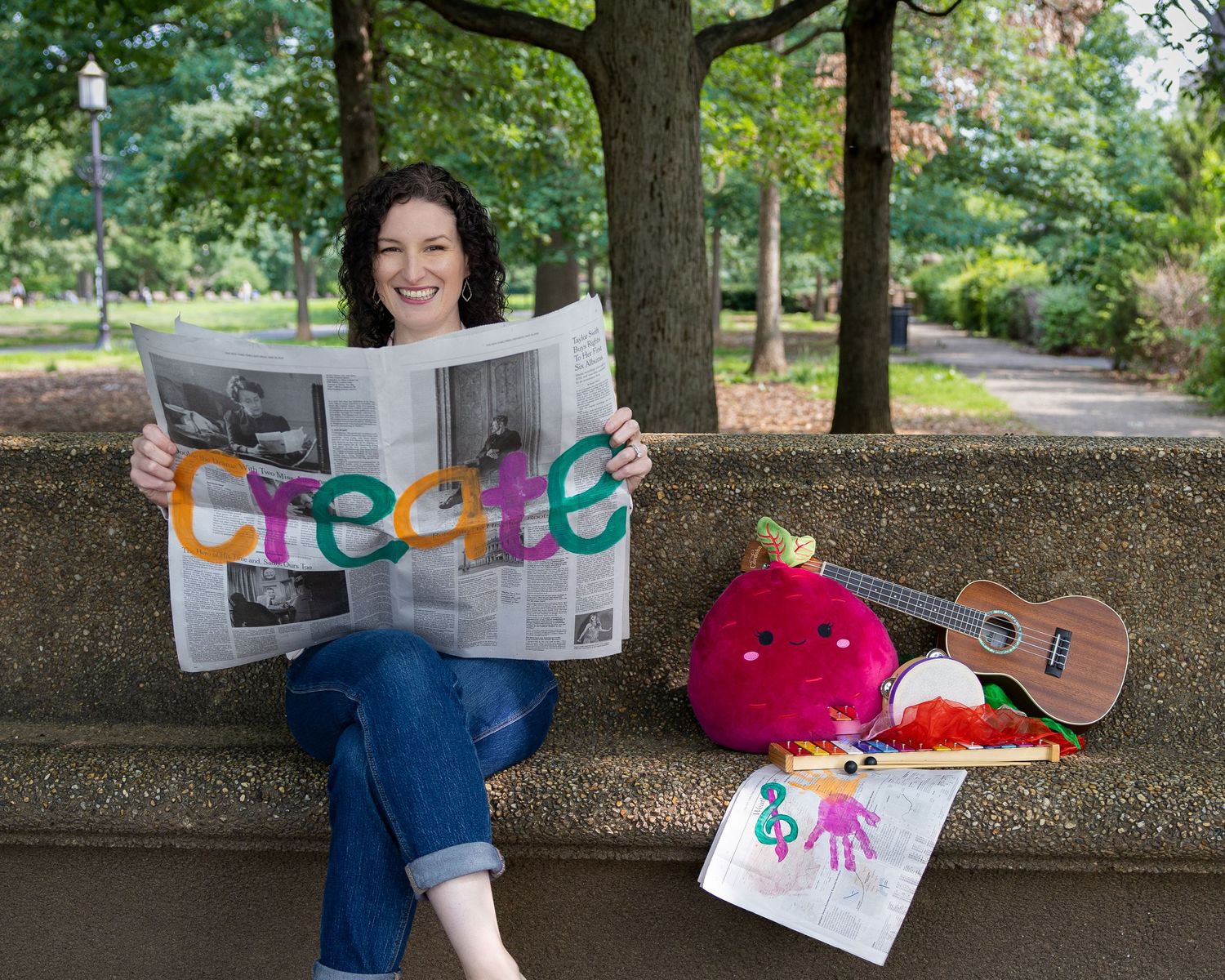 Creative lifestyle portrait holding newspaper with colorful lettering — storytelling portrait photography