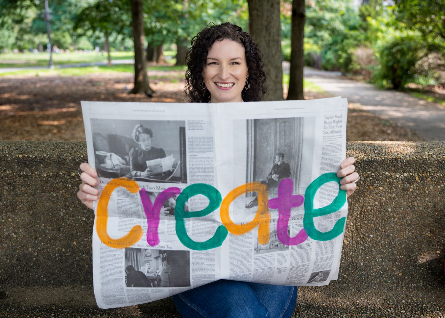 Creative lifestyle portrait holding newspaper with colorful lettering — storytelling portrait photography