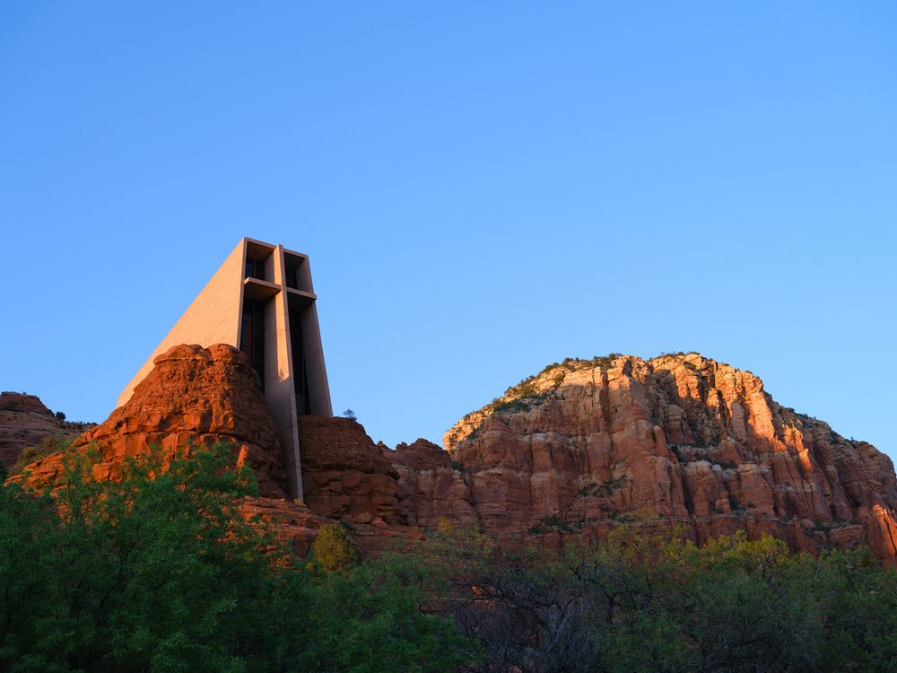 Chapel of the Holy Cross in Sedona, Arizona as the Golden Hour light adds color and drama to the red rock.