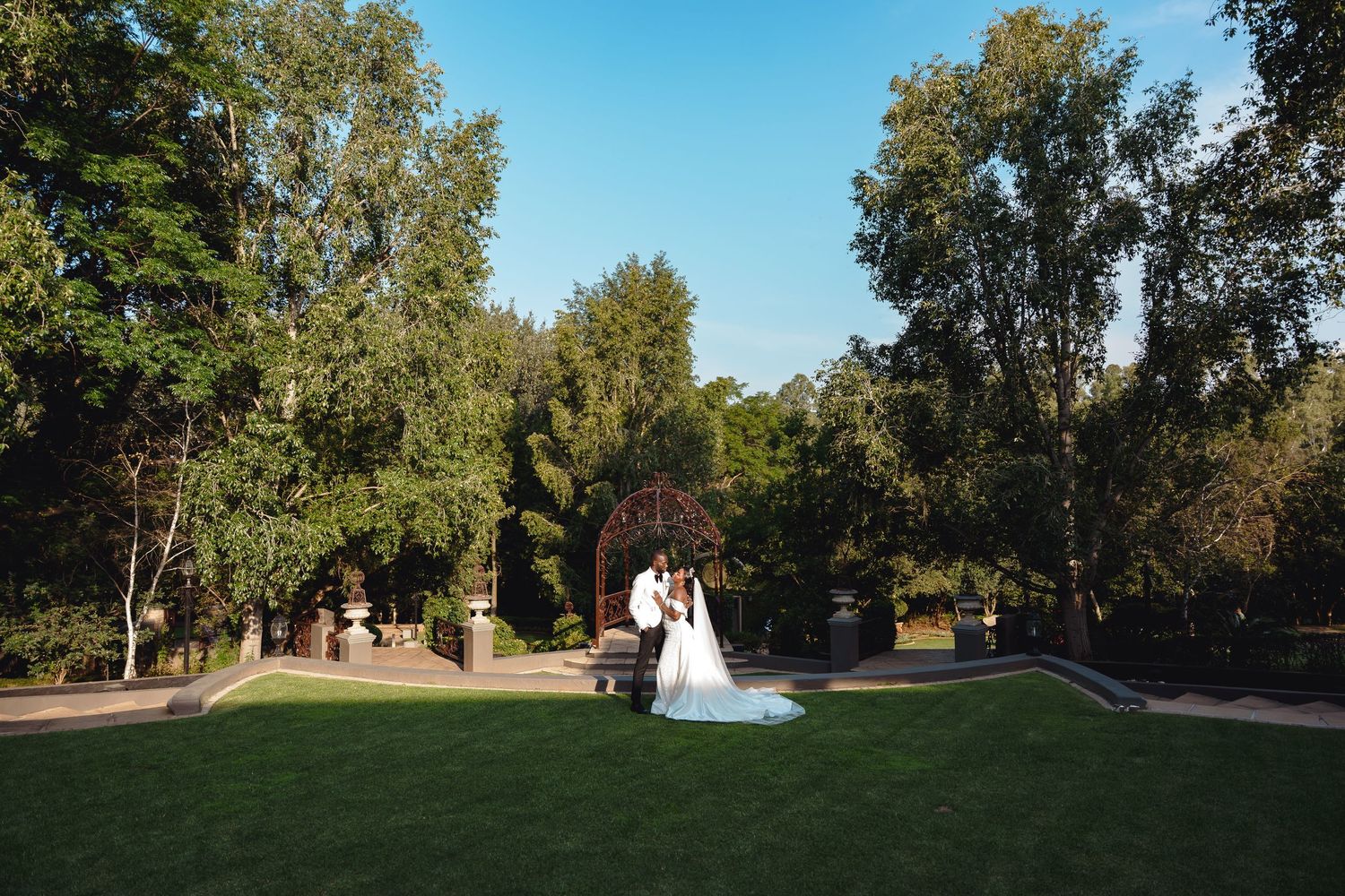 Panoramic sequence of a scenic outdoor wedding ceremony in a lush park setting during golden afternoon light.
