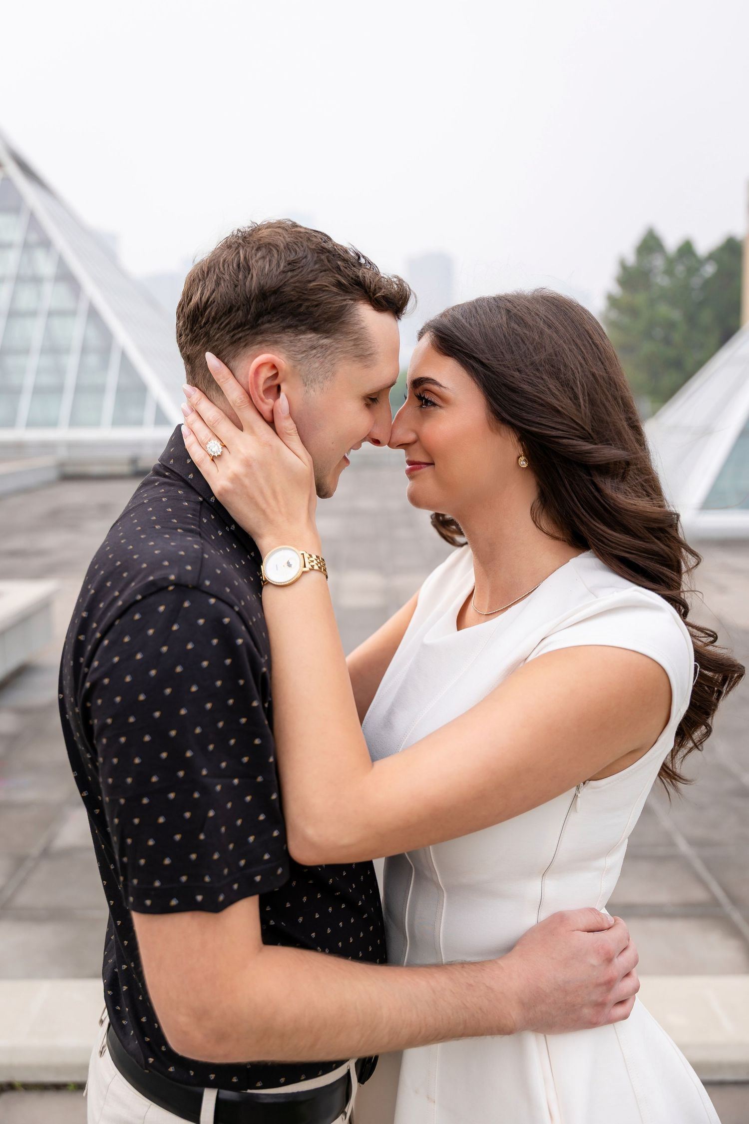 Couple in casual summer outfits standing together on a garden pathway.