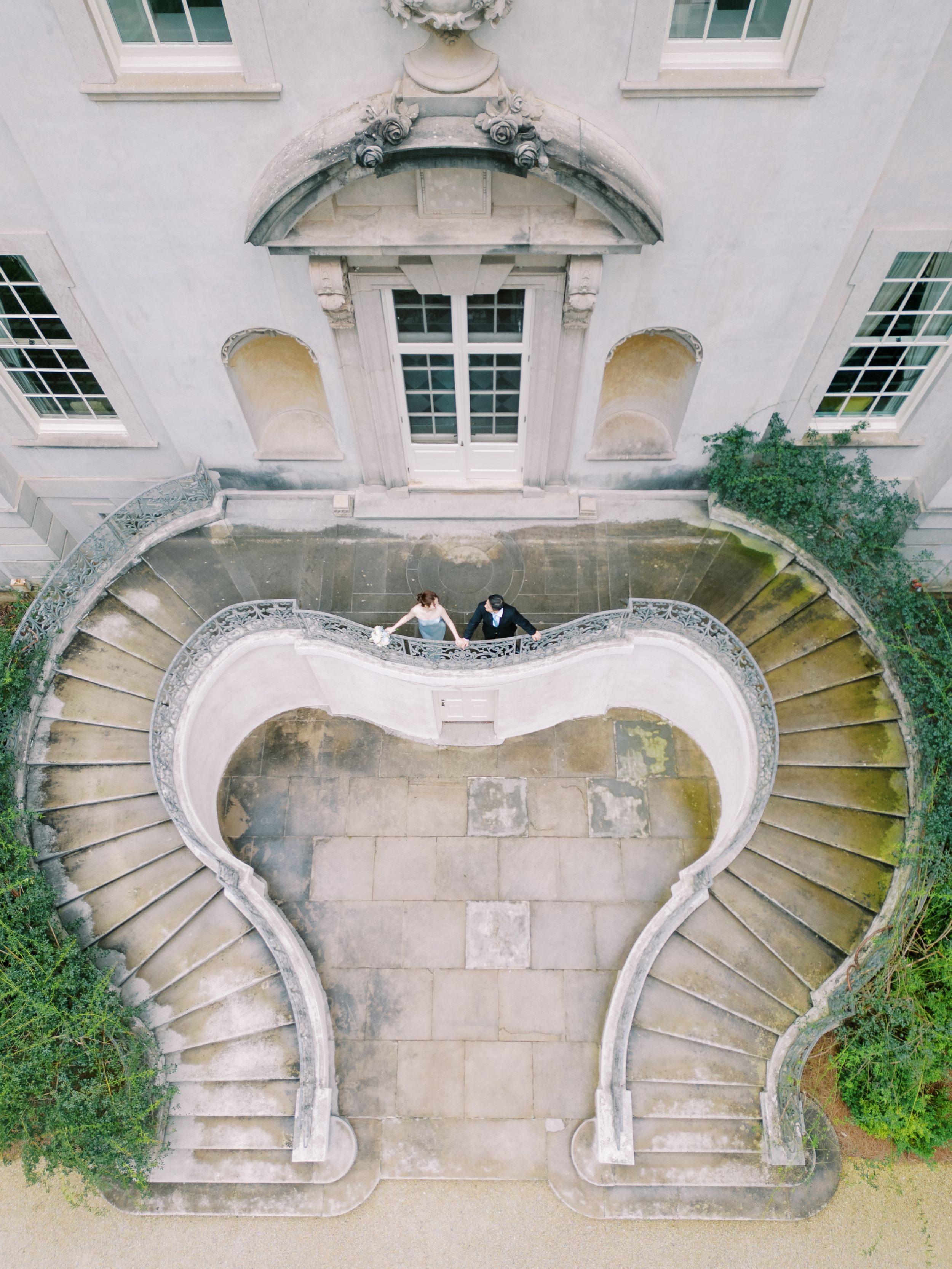 Sequence of aerial photos showing historic curved stone staircase against white building exterior with windows.