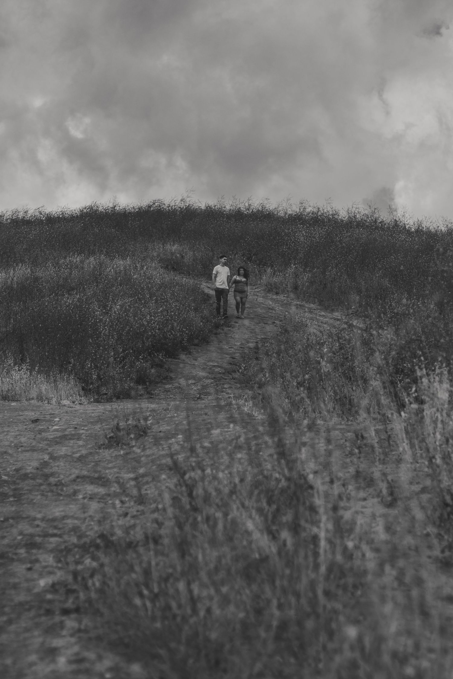Black and white portrait with grain, capturing a quiet, intimate moment between a couple
