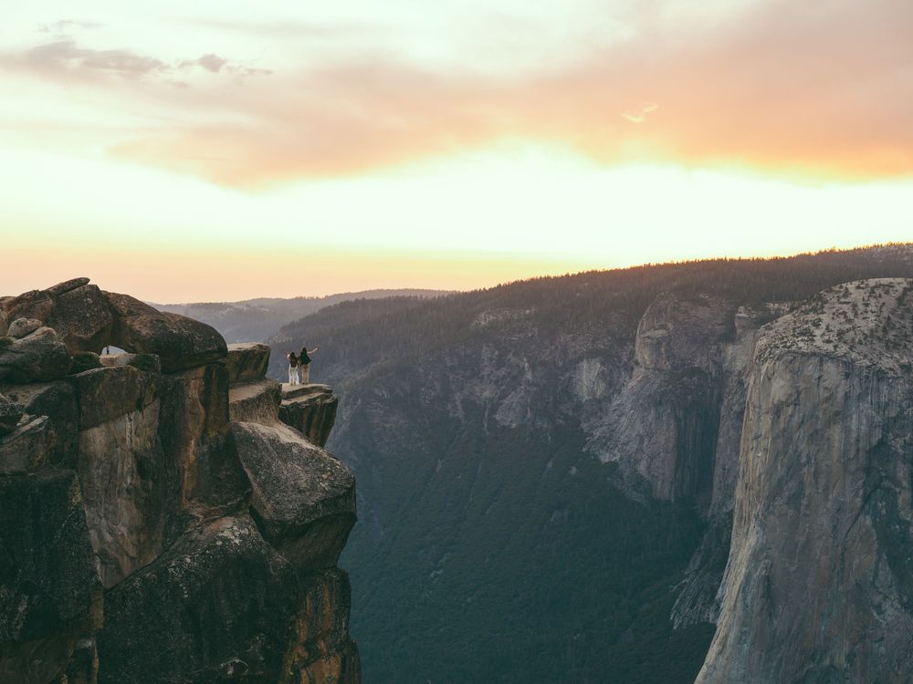 A breathtaking panoramic sunset view of the majestic cliffs and valleys of Yosemite National Park in golden light.