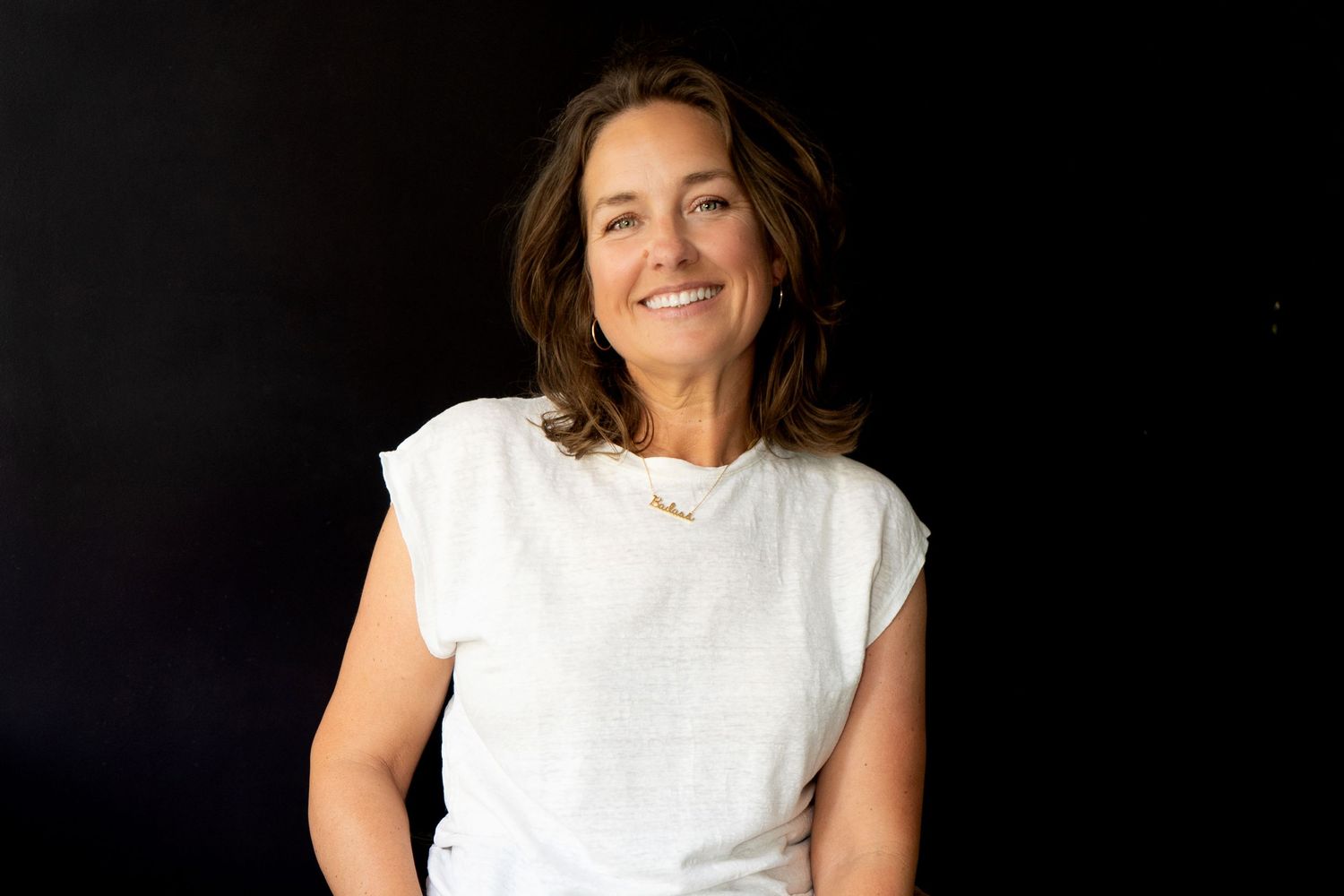 Professional branding portrait headshots of a female wearing a white top against a dark background.