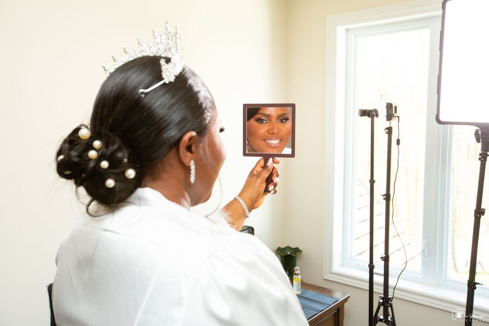 a bride looking at her own reflection in the mirror