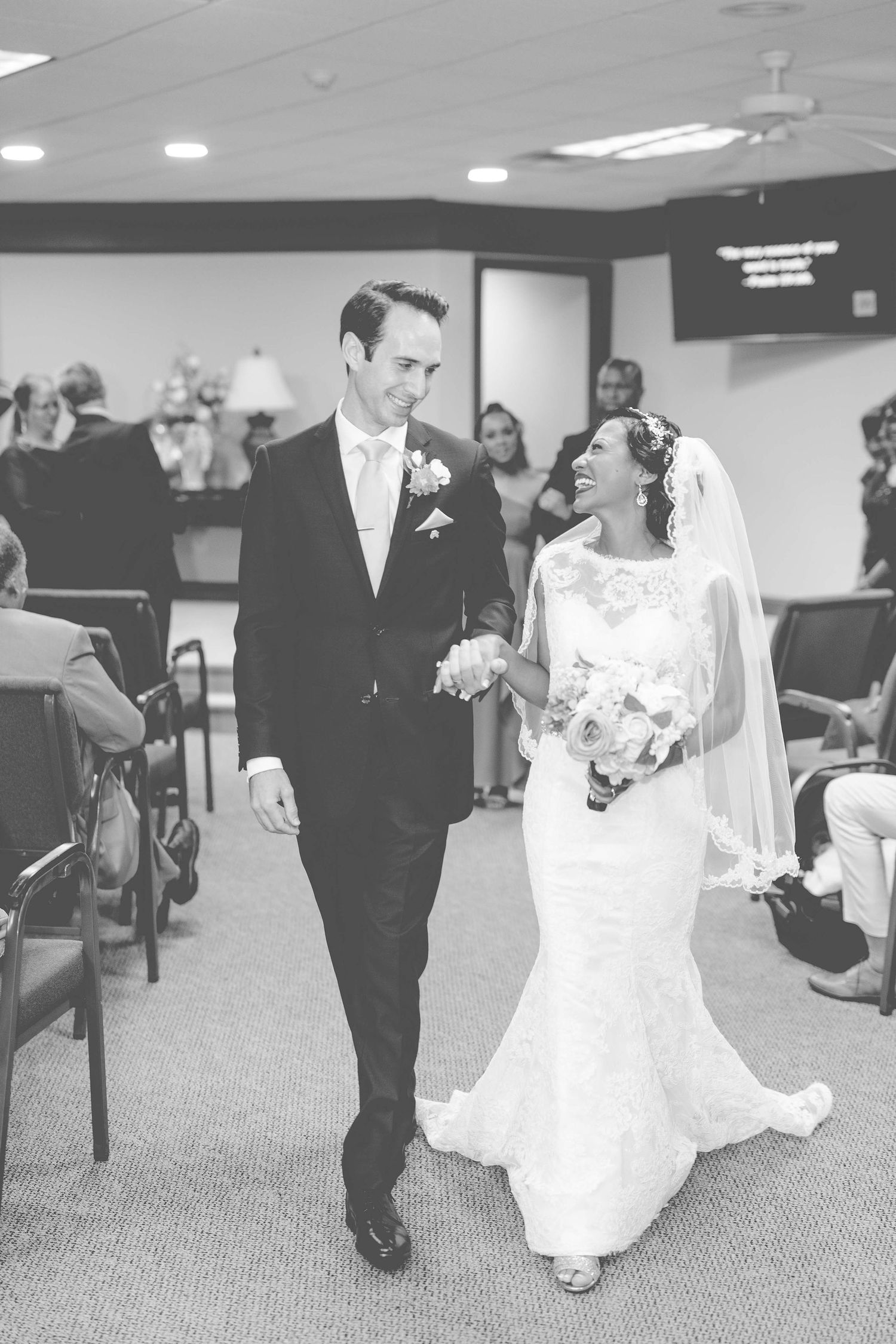 A sequence of black and white wedding photos showing a couple walking down a church hallway after their ceremony.