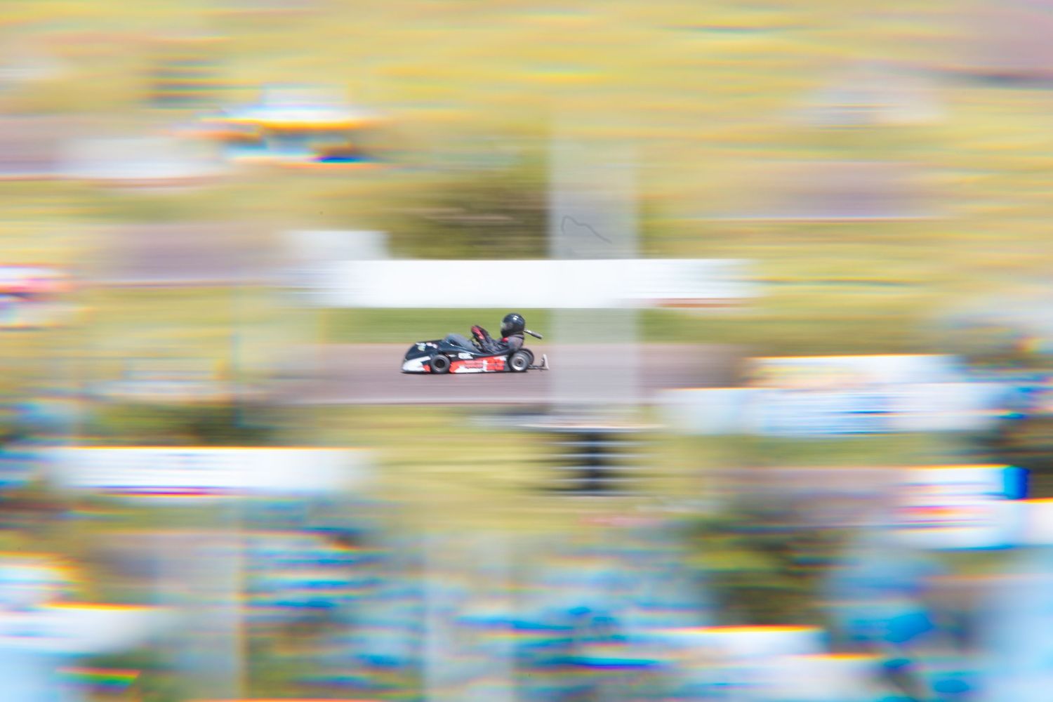 Go-karts battle for position at Poplar Grove Speedway, kicking up dust on a tight turn during heat races