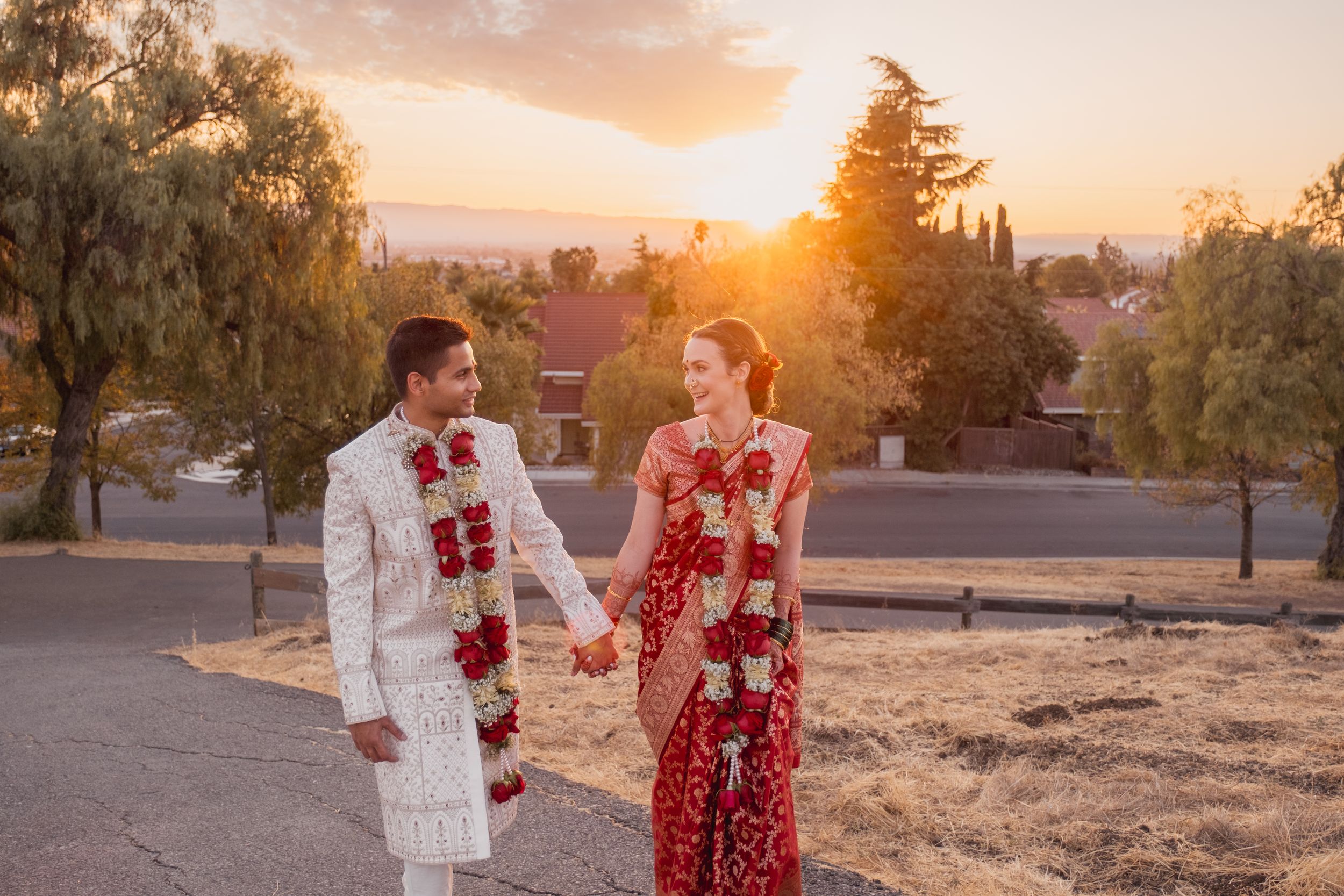 newly wed at a park during golden hour, holding hands.