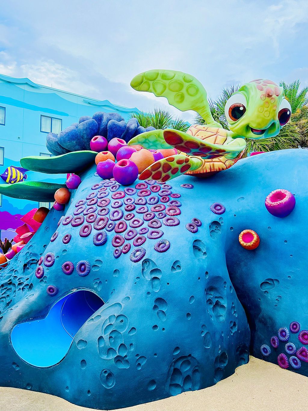Colorful sea turtle sculpture with decorative coral elements at Disney water park.