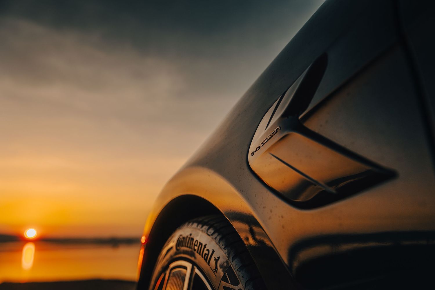 Close-up view of a BYD Dolphin Surf  rear LED light bar and badge in dramatic lighting.
