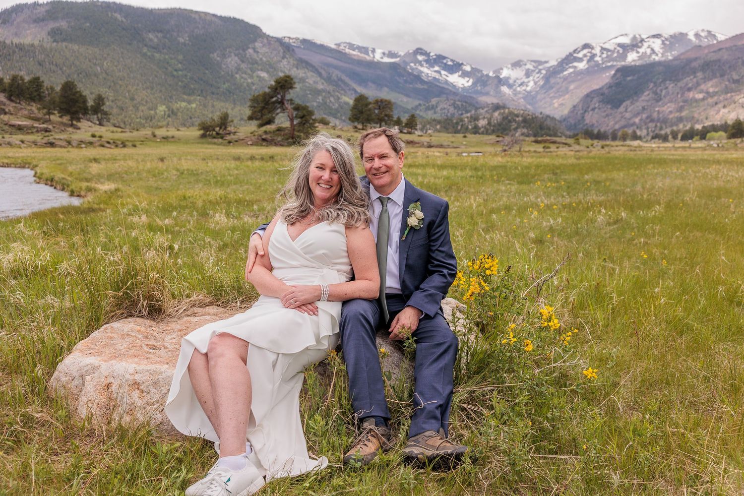 bride and groom in open meadow at Moraine Park, mountain views and elk nearby, fall elopement in Rocky Mountain National Park