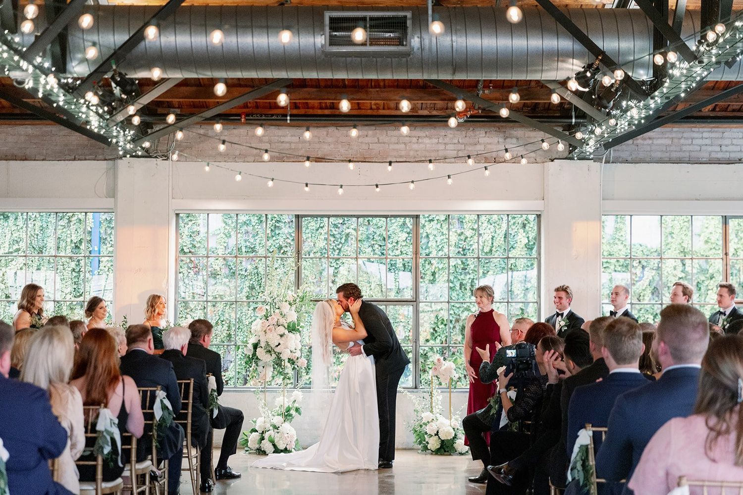 Couple kisses during ceremony at Hickory Street Annex, a Dallas wedding venue