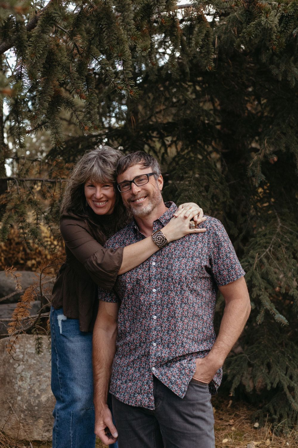A couple embracing and laughing together during an outdoor photo session.