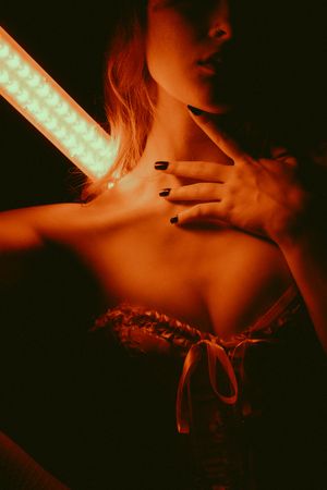 Artistic boudoir photography series in red lighting showing silhouetted figure against dark background.