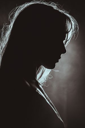 Dramatic black and white silhouette portraits showing the same profile in six different artistic lighting variations.