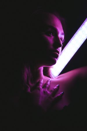 Artistic portrait series in purple lighting showing silhouettes of figures in dramatic side profiles against dark backgrounds.