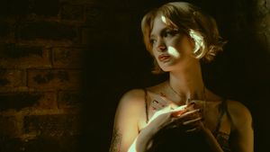 A collection of six dramatic black and white portraits with moody lighting and dark backgrounds.