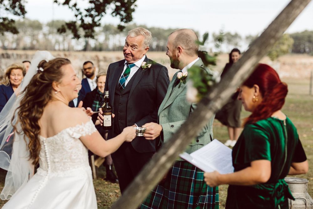 Guests mingle and socialize during an outdoor wedding celebration.