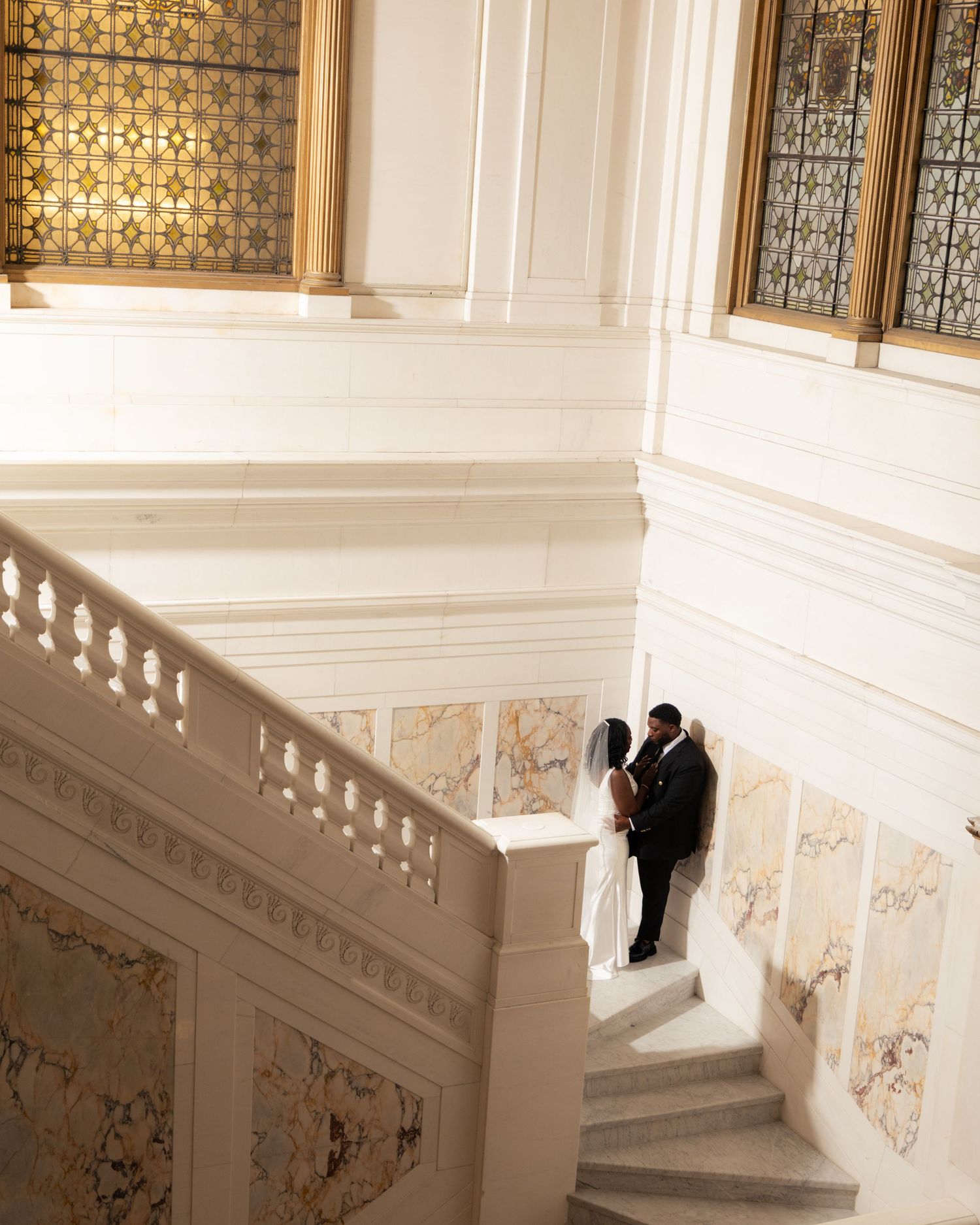 Artistic wedding photography sequence on elegant white marble staircase. At the Kimpton Hotel in Baltimore Maryland