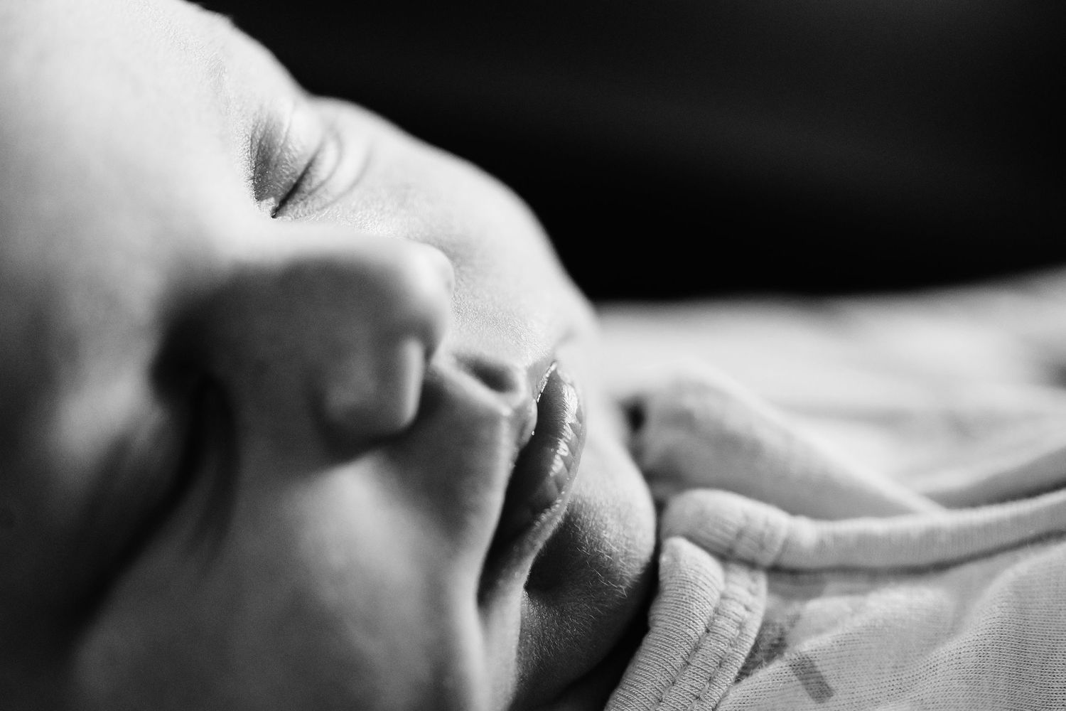 A series of black and white close-up photographs showing infant macro images in lifestyle photo session.