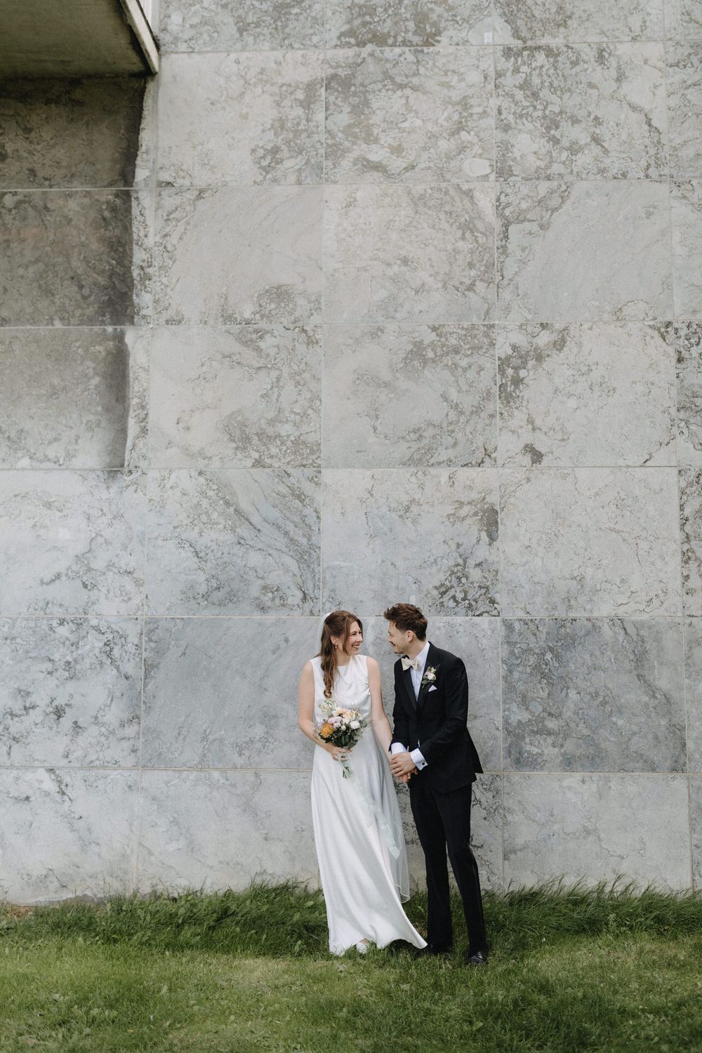A romantic wedding sequence showing a couple in front of Aarhus Rådhus