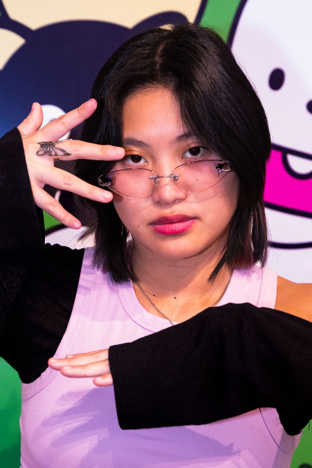 A series of four selfie-style photos showing someone with dark hair making peace signs and playful expressions.