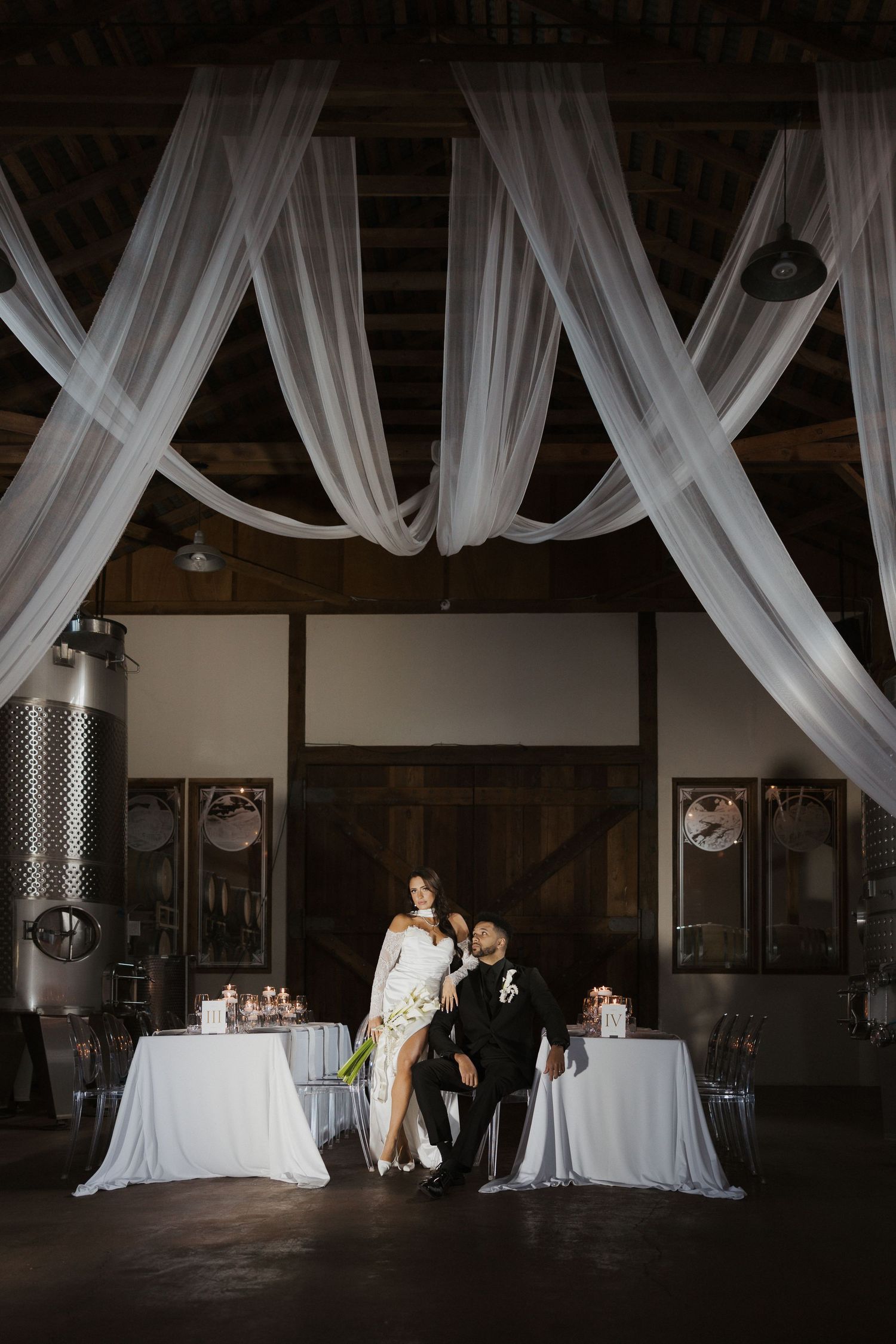Elegant wedding reception venue with white drapes and tables showcasing a romantic lighting progression from dark to bright.