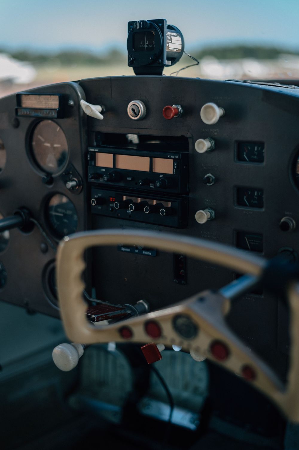 Interior cockpit dashboard of a small aircraft showing various instruments and controls.
