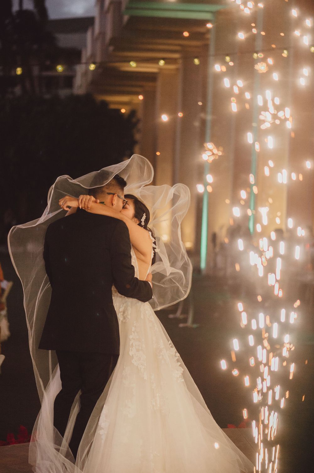 Romantic wedding dance moment with sparkling lights creating magical atmosphere.