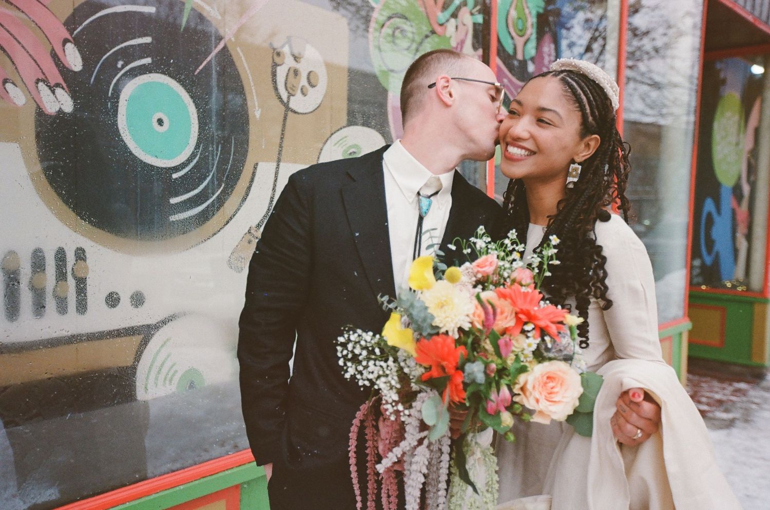 A wedding celebration with vinyl records and colorful flowers decorating the venue.